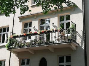 un edificio con un balcón con flores. en Botaniczny Pokój, en Cracovia