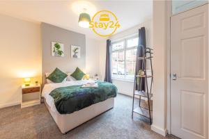 a bedroom with a bed and a ladder and a window at Elizabeth Place in Crewe