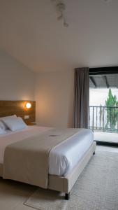 a bedroom with a large bed and a large window at Adaka in Oiartzun