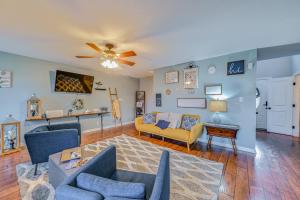 a living room with couches and a ceiling fan at Family-Friendly Clarksville Home with Fire Pit! in Oak Grove
