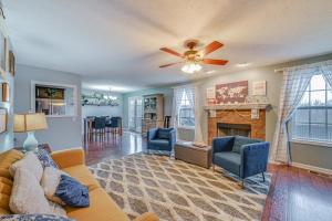 a living room with a couch and a fireplace at Family-Friendly Clarksville Home with Fire Pit! in Oak Grove