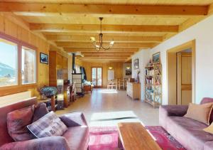 a living room with two couches and a table at Chalet authentique avec magnifique vue in Cerniat