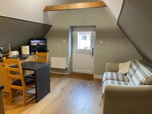 a living room with a table and a couch at Braemorriston Lodge in Elgin