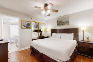 a bedroom with a bed and a ceiling fan at Sea Oats 208 in Fort Walton Beach