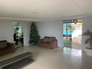 a living room with a christmas tree and a couch at Hotel Turístico de Alagoinhas in Alagoinhas