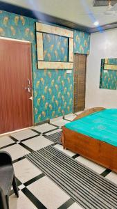 a bedroom with a bed and a door in a room at Radhey Krishna home stay in Mathura