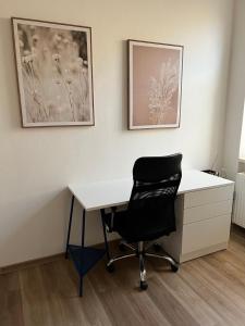 a white desk with a black chair in a room at Sušilova 14 apartments III in Přerov