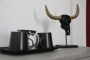 a couple of cups with horns on a shelf at Bed and Breakfast Donna Maria in Bari