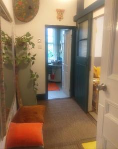 a hallway with a door leading to a kitchen with a sink at Jesmond B&B Kingsize Ensuite Room 2 in Hull