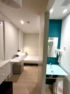 a bathroom with a sink and a toilet and a tub at Urban Sea Hotel Atocha 113 in Madrid