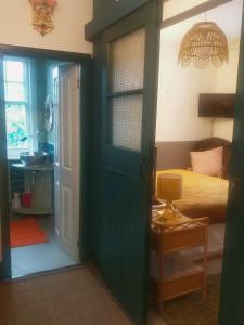 a bedroom with a green door and a bed at Jesmond B&B Kingsize Ensuite Room 2 in Hull