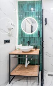 a bathroom with a sink and a mirror at New Gudauri Sweet Apartment With Fireplace and view The Gondola Lift in Gudauri