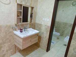 a bathroom with a sink and a shower and a toilet at شاليه لارا in Rayyis +20 photos