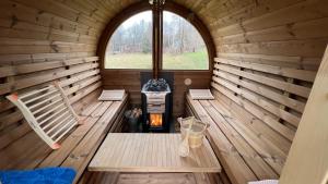 an inside view of a wooden sauna with a fireplace at Ferienwohnung Spreebogen in Sohland