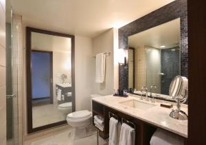 a bathroom with a sink and a toilet and a mirror at InterContinental New York Times Square by IHG in New York