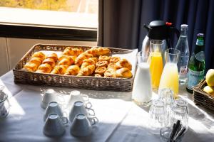 a table with a basket of donuts on a table at Campanile Limoges Centre - Gare in Limoges +132 photos
