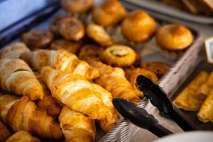 a bunch of croissants and other baked goods on display at Campanile Limoges Centre - Gare in Limoges