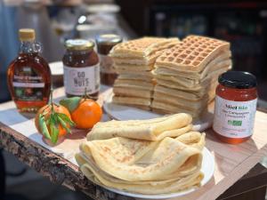a table topped with pancakes and waffles and syrup and waffles gmaxwell at Best Western Plus Thionville Centre in Thionville +100 photos