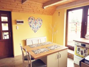 a kitchen with a table with a heart on the wall at Agroturystyka Od Kaszuba in Żuromino