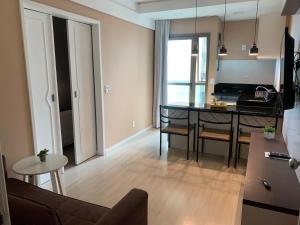 ein Wohnzimmer mit einer Küche und einem Esstisch in der Unterkunft Ocean Flat Premium com vista para o mar in Vila Velha