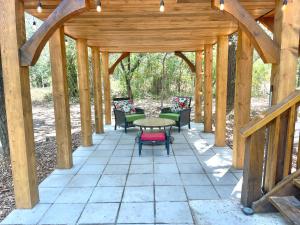 drewniana pergola ze stołem i krzesłami na patio w obiekcie Hideout Ridge 