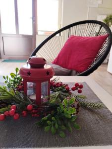 a table with a lantern and christmas decorations on it at Apartman Talija in Arandjelovac