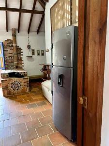 a kitchen with a stainless steel refrigerator in a room at Finca Sierra Luz in Jericó