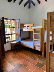 a room with two bunk beds in a house at Finca Sierra Luz in Jericó