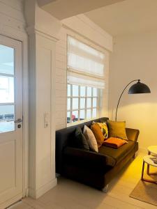 een woonkamer met een bank en een raam bij Zur Bademutter mit 2 Schlafzimmer - ABC360 in Wismar