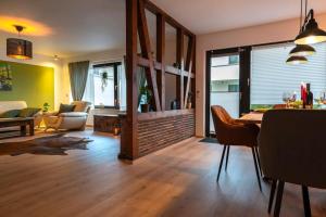 a living room with a table and a dining room at idyllisches Traumhaus mit Garten in Emmelshausen