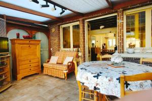 a room with a table and a chair and a room with a table at La Cambresienne de Mamie in Cambrai