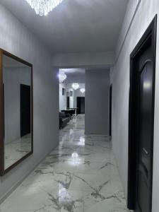 a hallway with a mirror on the wall and a room with a table at MODERN House in Sighetu Marmaţiei