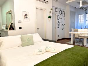 a white bed with two pillows on it in a room at [150m to Metro A] 3 Bedrooms & 2 Bathrooms - Family friendly in Rome