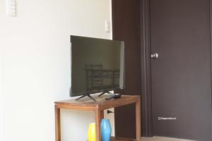 una TV a schermo piatto seduta sopra un supporto in legno di Casa completa 3D 2B, amplia comoda y equipada a Talca