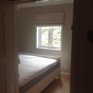 a bed in a room with a window at Utsiktsperle på Reine I Lofoten in Reine