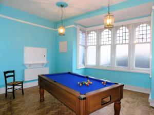 a pool table in a room with blue walls at The Old Town Hall in Sheringham