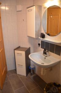 a bathroom with a sink and a mirror at Bergbauernhof Obergaisberg in Kirchberg in Tirol