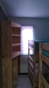a bedroom with two bunk beds and a window at Pucón Rec-Lodge Camino al Volcan in Pucón