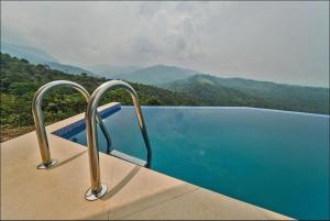 a swimming pool with a view of the mountains at Vista escalera lodge in Tarapoto