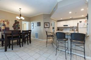 a kitchen and dining room with a table and chairs at Martinique 203 West in Gulf Highlands