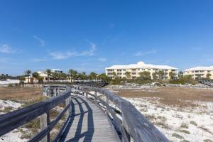 a wooden boardwalk leading to a beach with condos at Martinique 203 West in Gulf Highlands