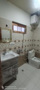 a bathroom with a sink and a toilet at swayambhu homestay in Joshīmath