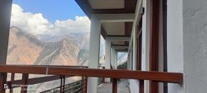 a balcony with a view of the mountains at swayambhu homestay in Joshīmath