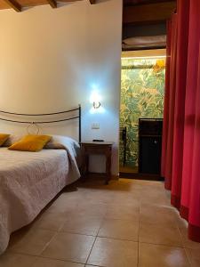 a bedroom with a bed and a painting on the wall at Agriturismo La Luciana in Castiglione della Pescaia