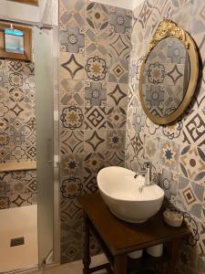 a bathroom with a sink and a mirror at Agriturismo La Luciana in Castiglione della Pescaia