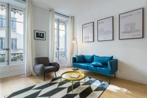 a living room with a blue couch and a chair at Hallmark - Location T2 - Lyon 2 in Lyon