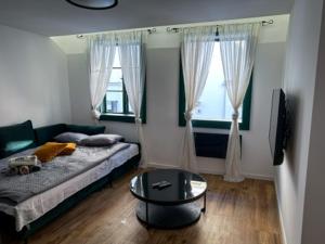 a bedroom with a bed and a coffee table at Old Roofs in Zagreb