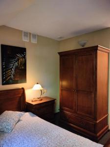 a bedroom with a large wooden cabinet and a bed at Kasztanowy Dwór in Cieszyn