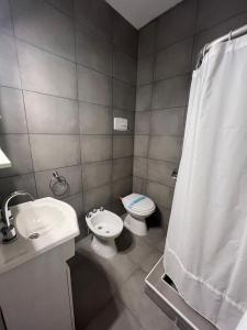 a bathroom with a toilet and a sink and a shower at La Cibeles in Miramar