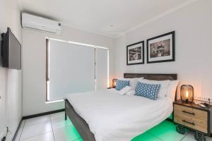 a bedroom with a large white bed and a window at Nova Luxury Suites Fourways in Johannesburg